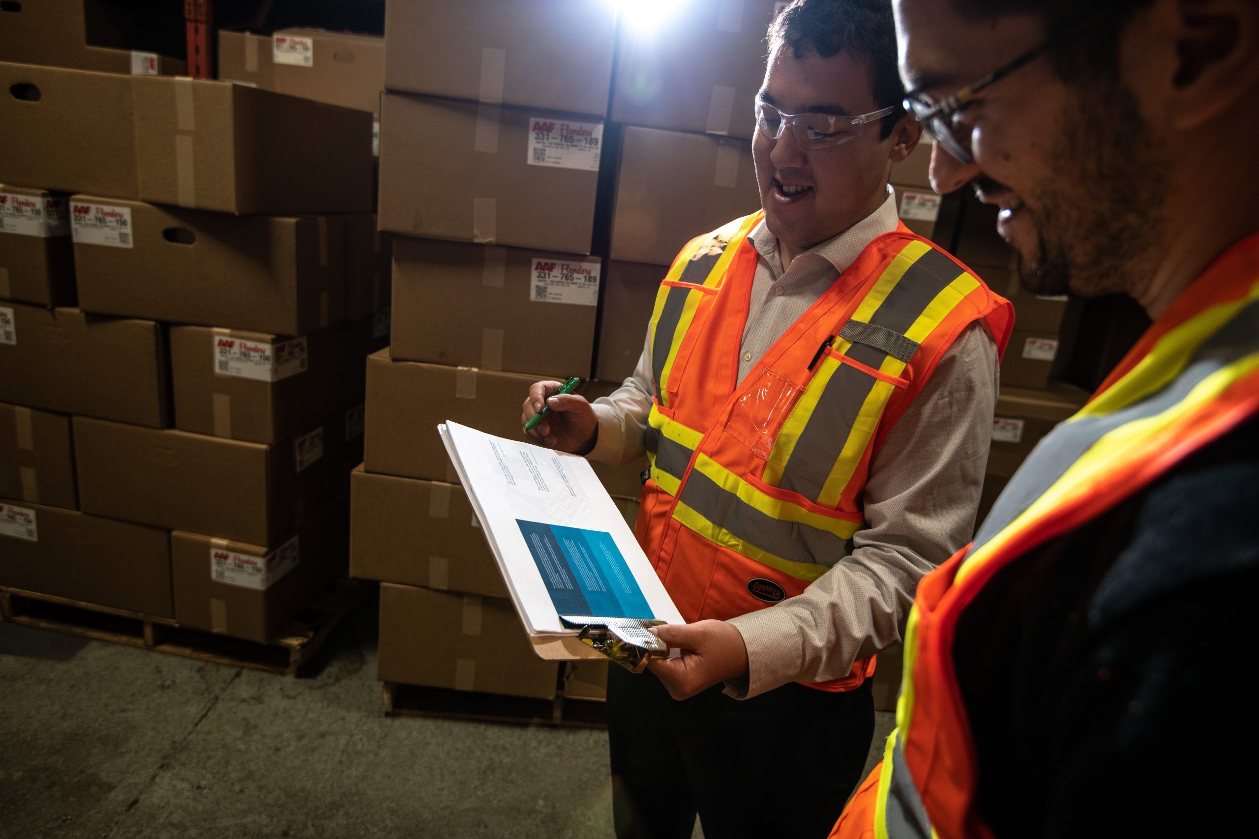 Two workers discussing something in a warehouse